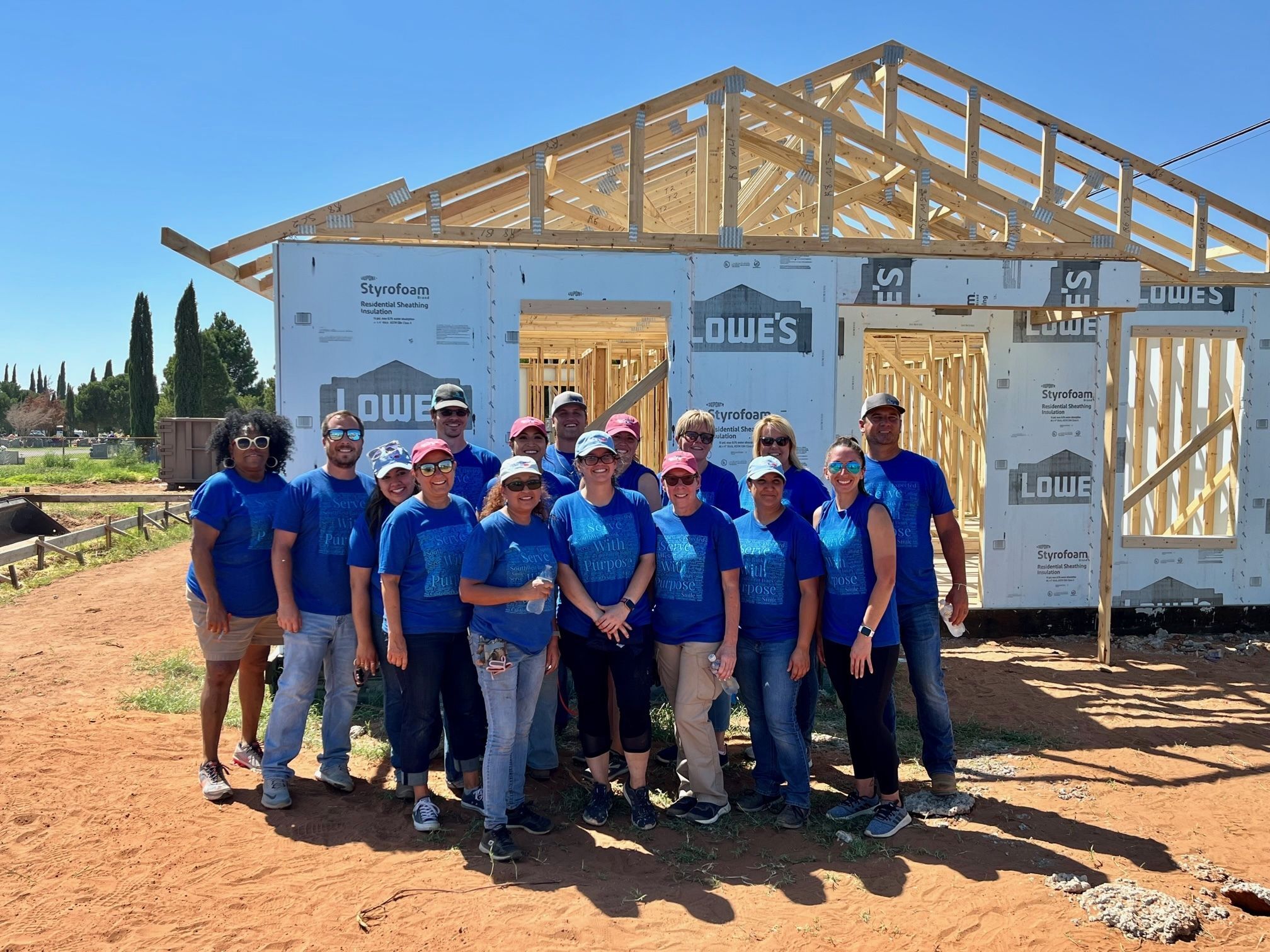 Volunteers in front of house