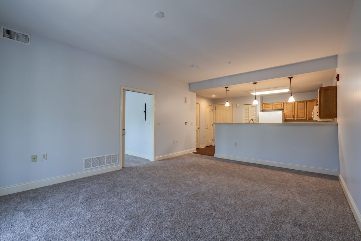 Colden living room with view toward kitchen and entry