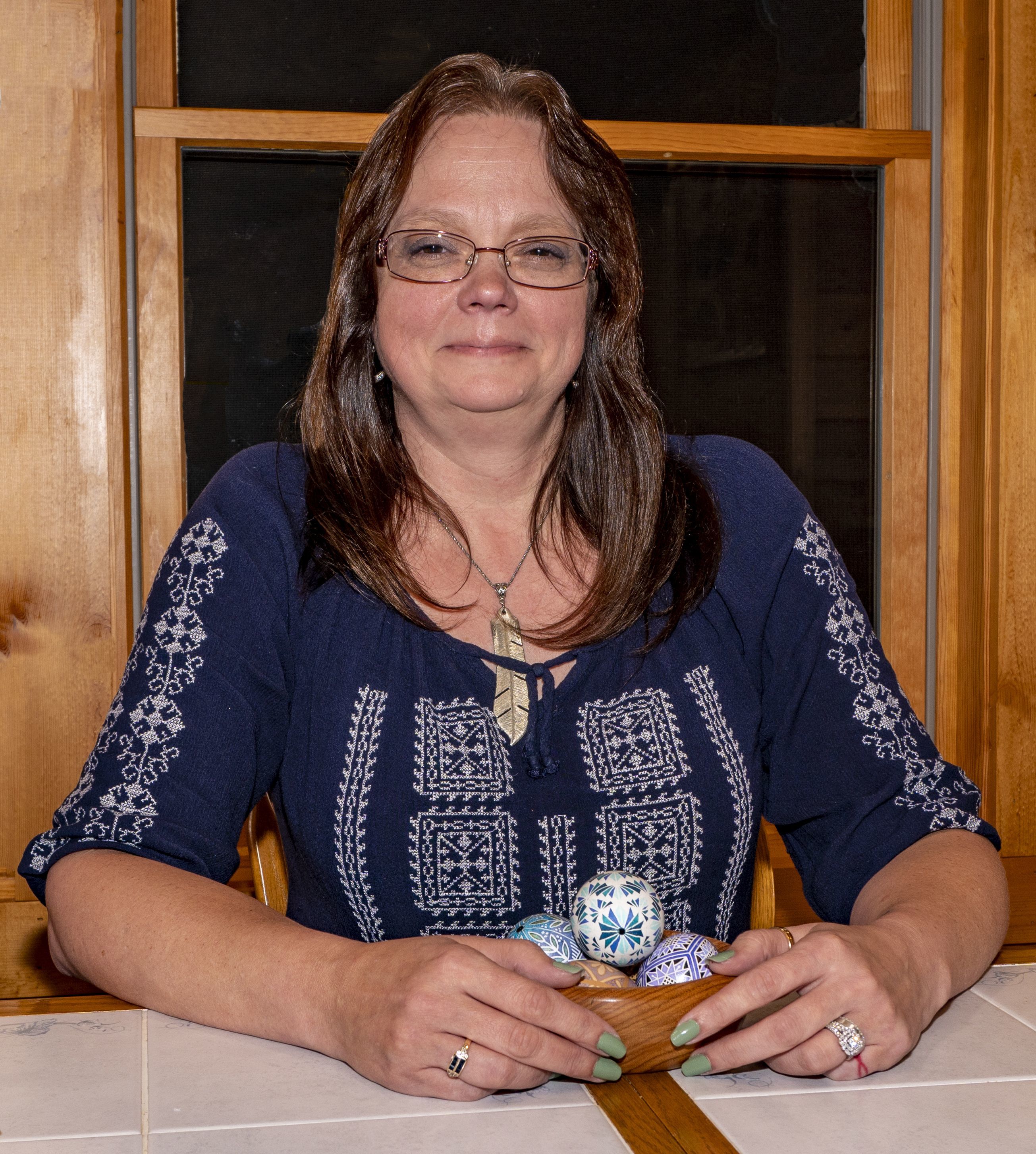 Pysanky egg artist Jennifer Fleszar poses with an example of her decorated eggs.