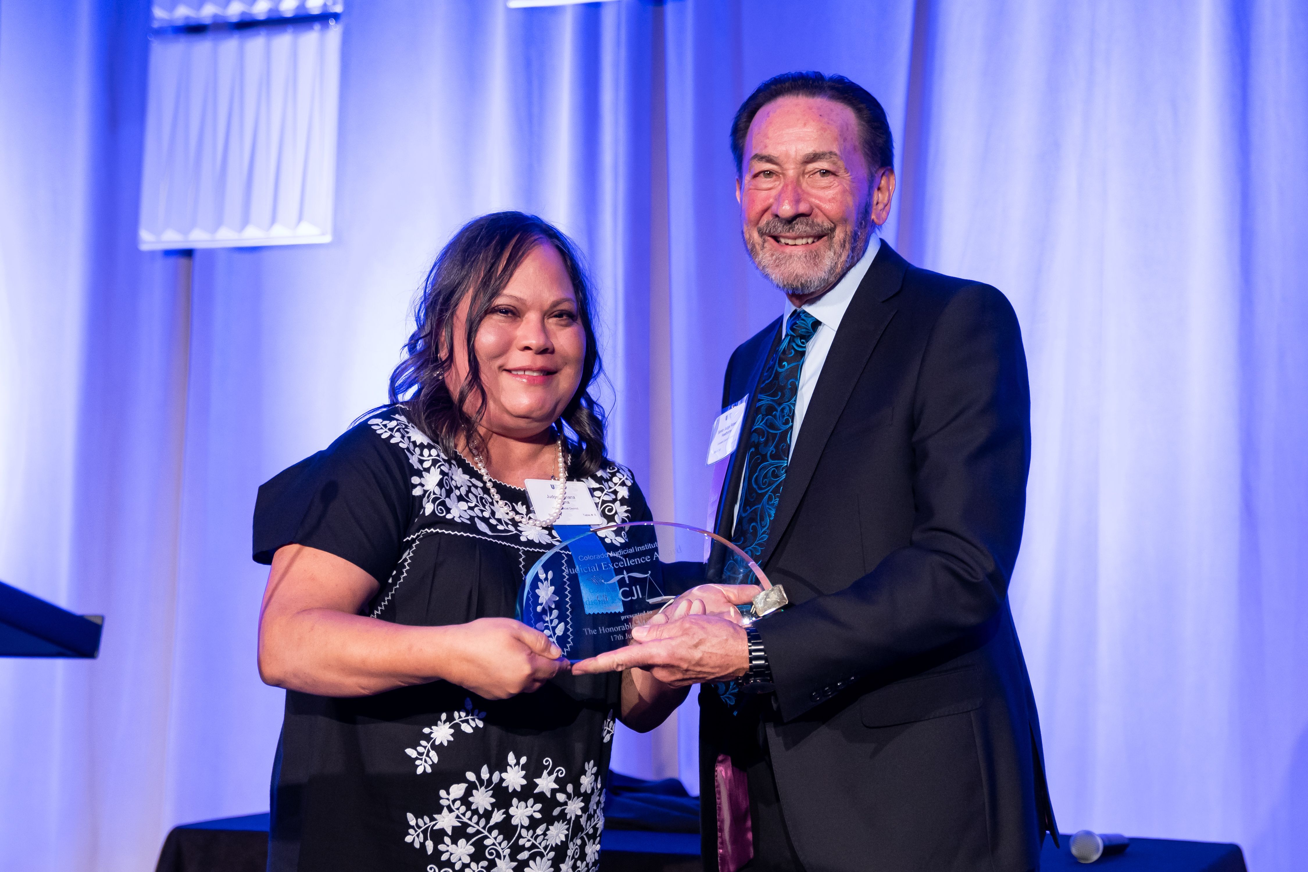 Judge Mariana Vielma accepts her award from Judge Robert Hawthorne, the chair of CJI's Awards Committee