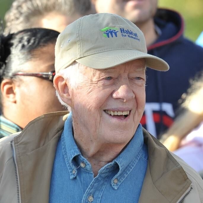 Jimmy Carter smiling in a Habitat for Humanity Hat.