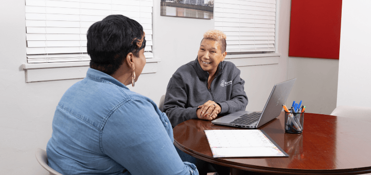 A case manager at Home for Families meets with a client to help them find housing
