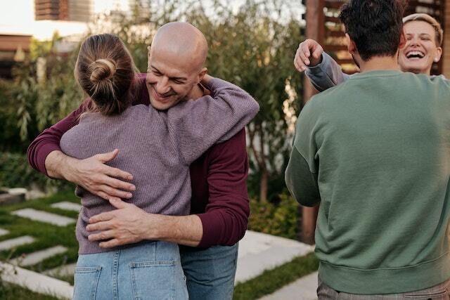 Diverse people hugging each other