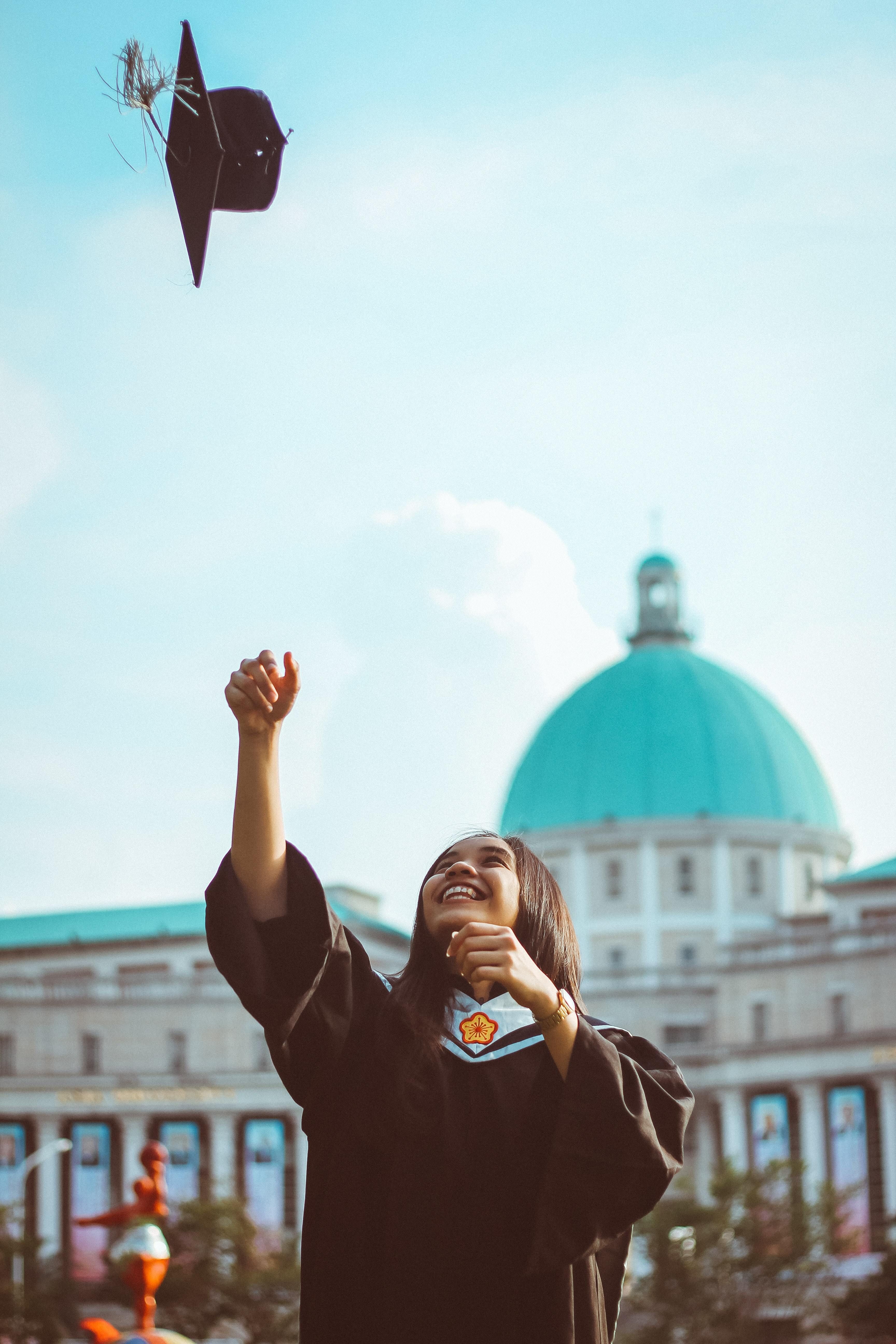 Graduate throwing cap into the air