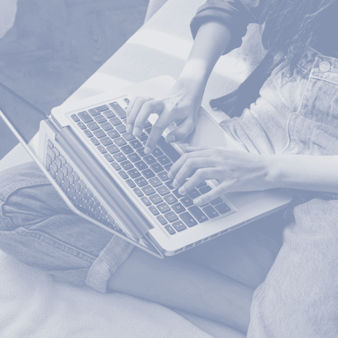 Woman typing with laptop on her lap