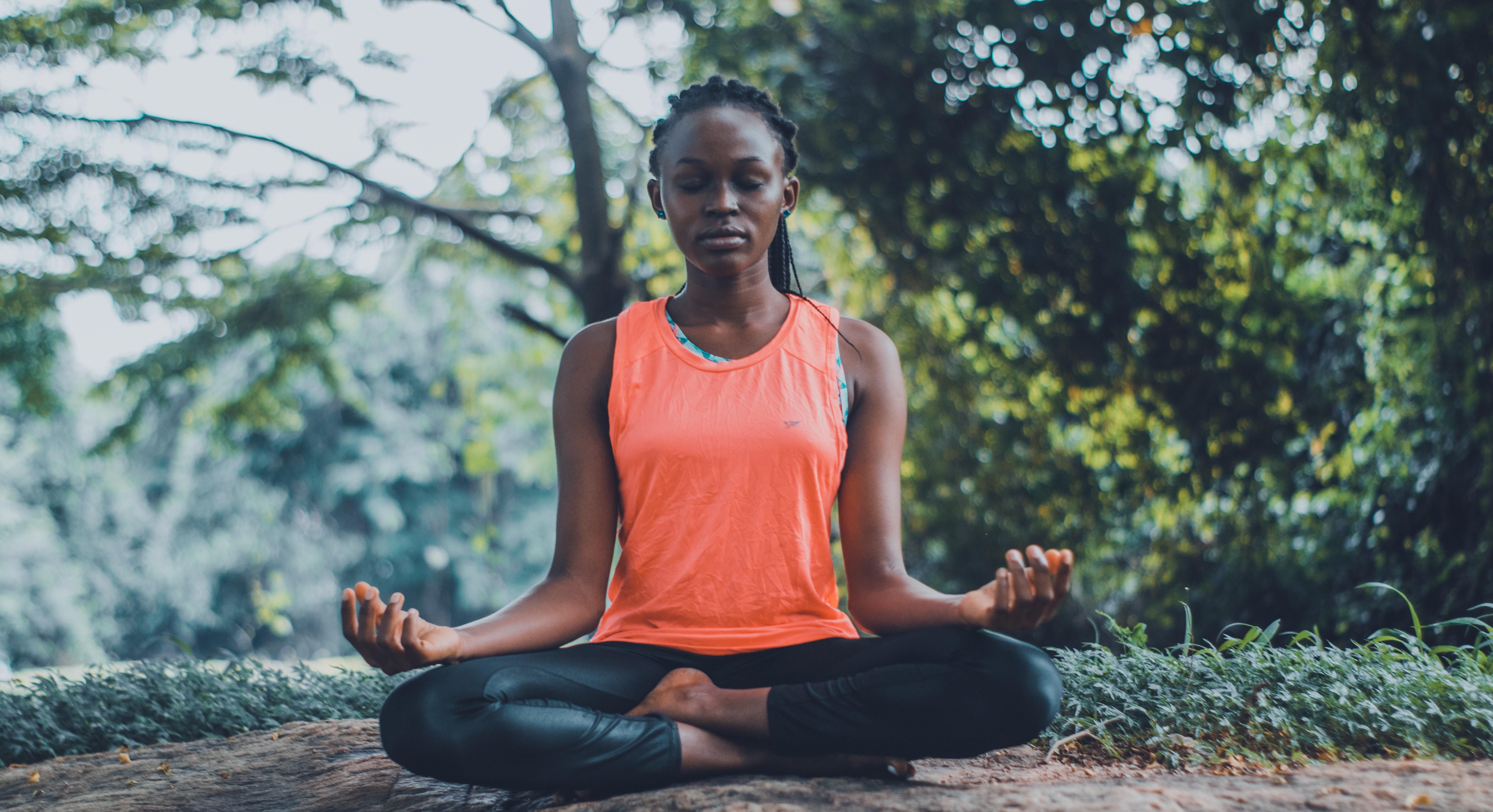 woman meditating in park