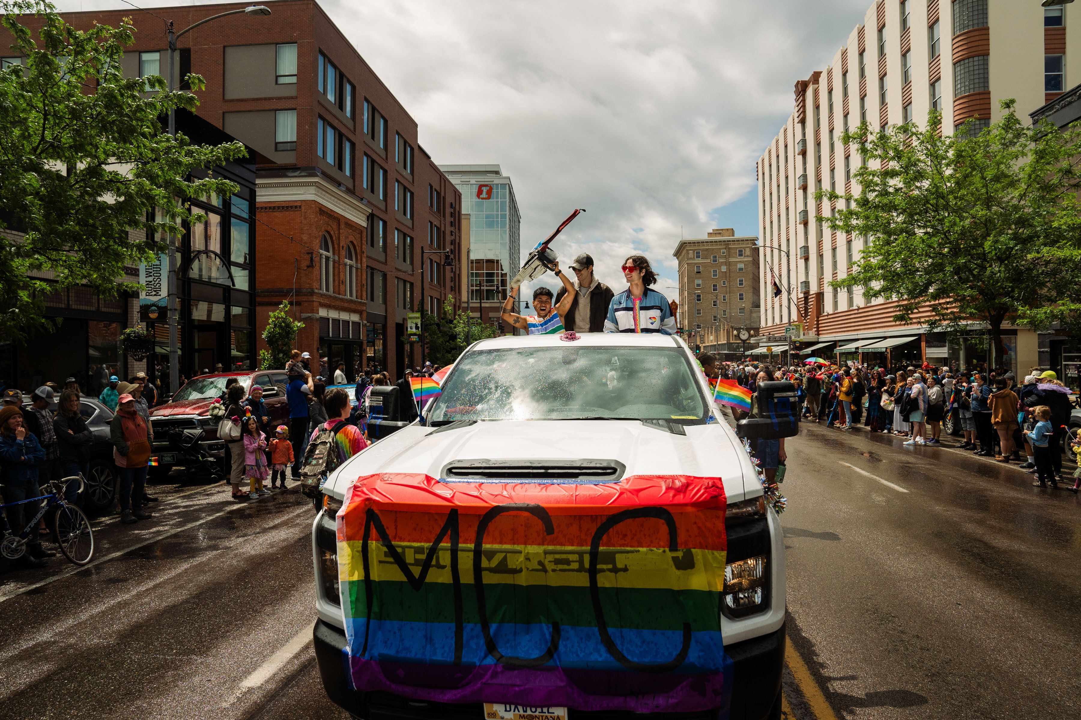 An MCC truck with a Pride Flag on it drives down the street during Missoula Pride