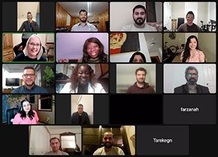 Many faces on a computer screen during a zoom session for an online class.