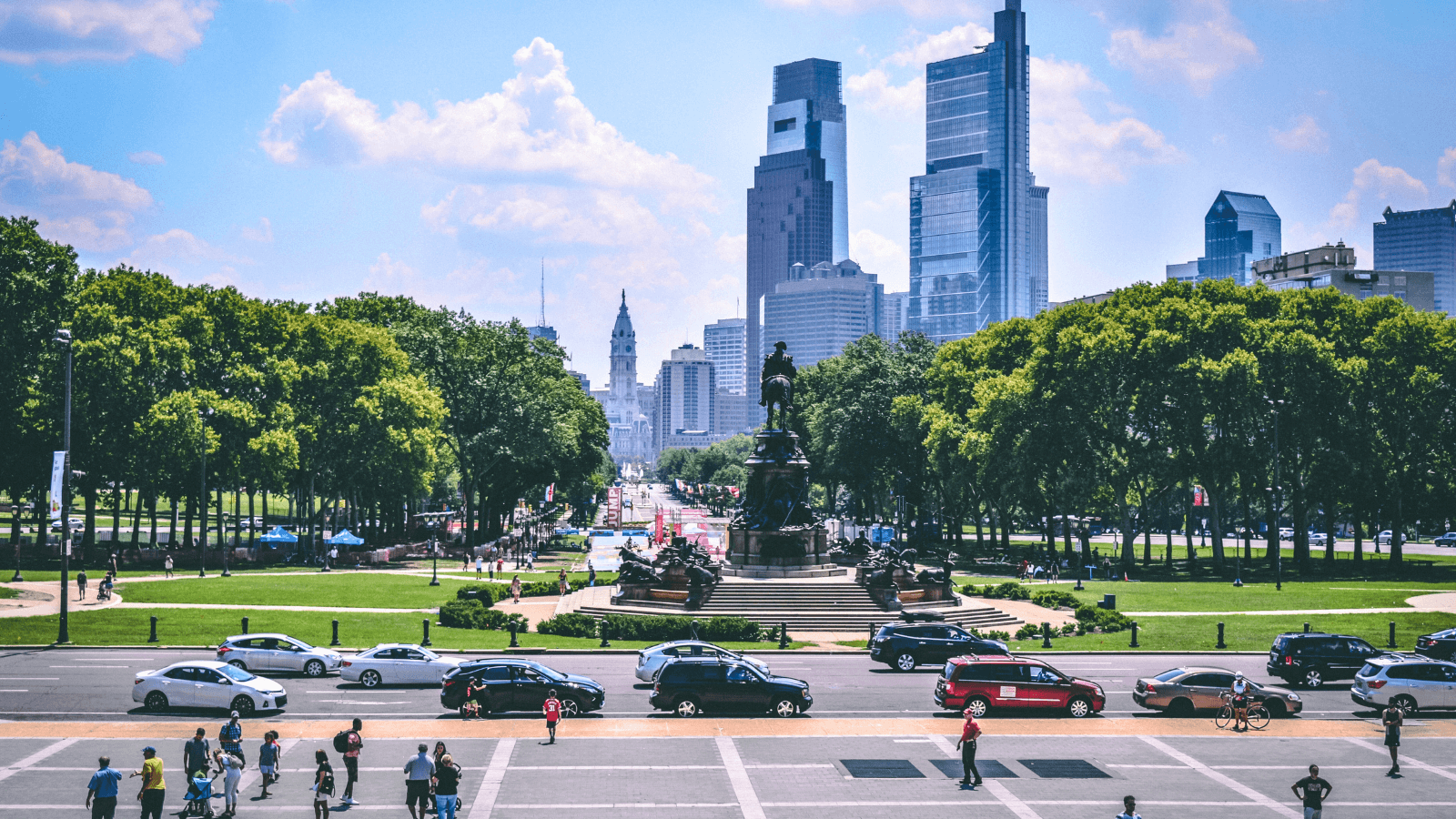Daytime in Philadelphia, PA with people and cars moving around the city