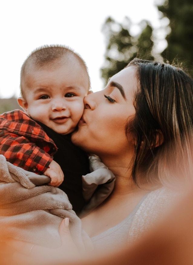 Mom kissing her baby