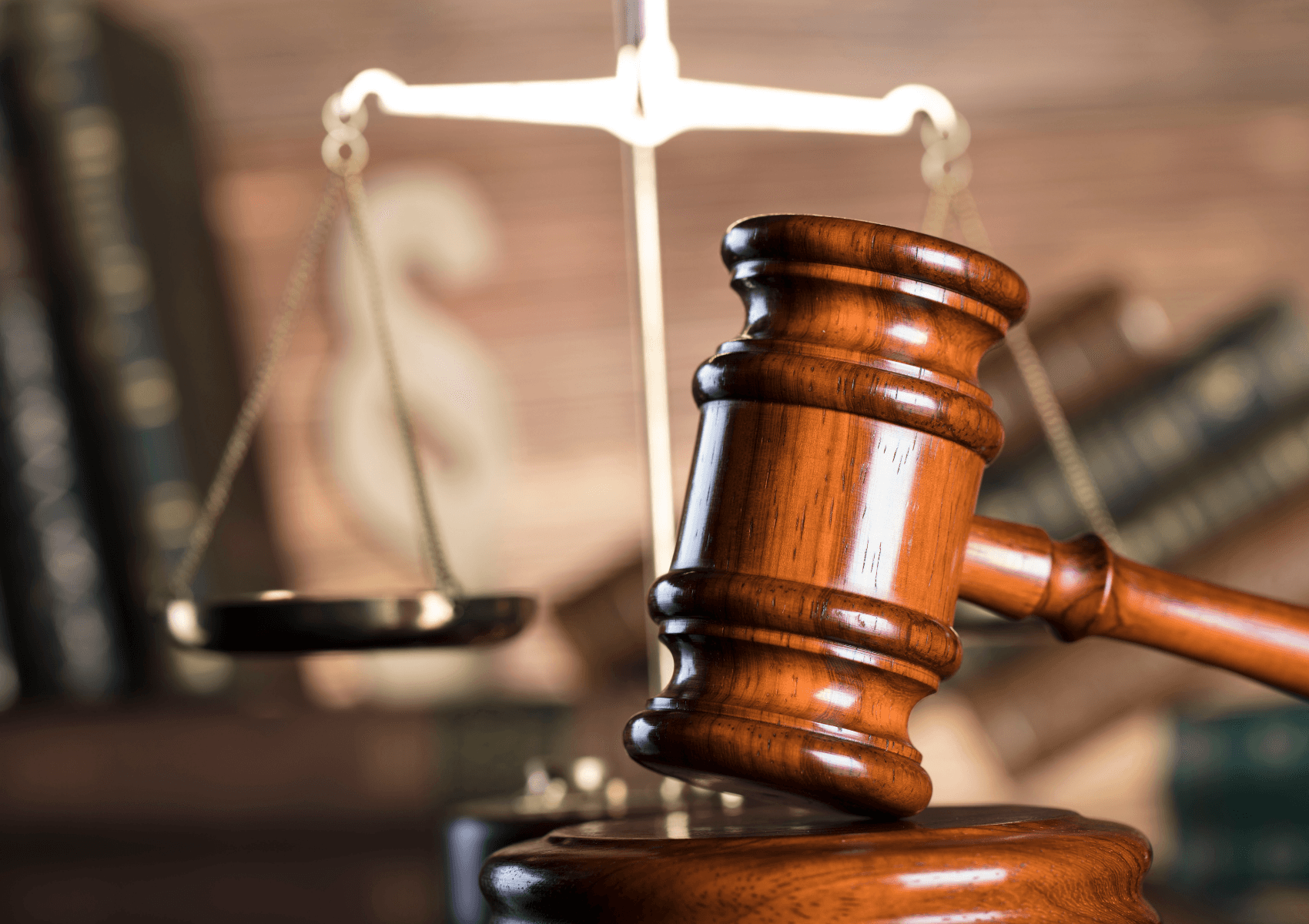 Image of two people holding hands in comforting manner. Only the hands are visible.