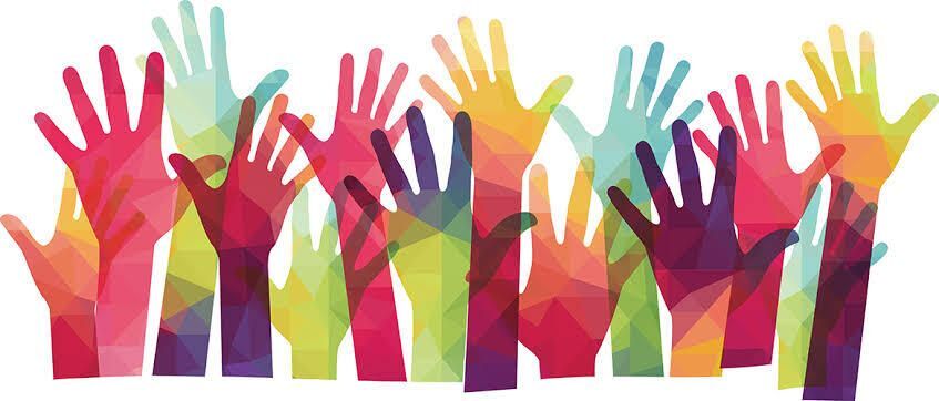 Colorful hands raised in support, symbolizing volunteers coming together for the Mapleton Education Foundation