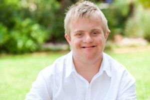 Young man with blonde hair outdoors in the sun