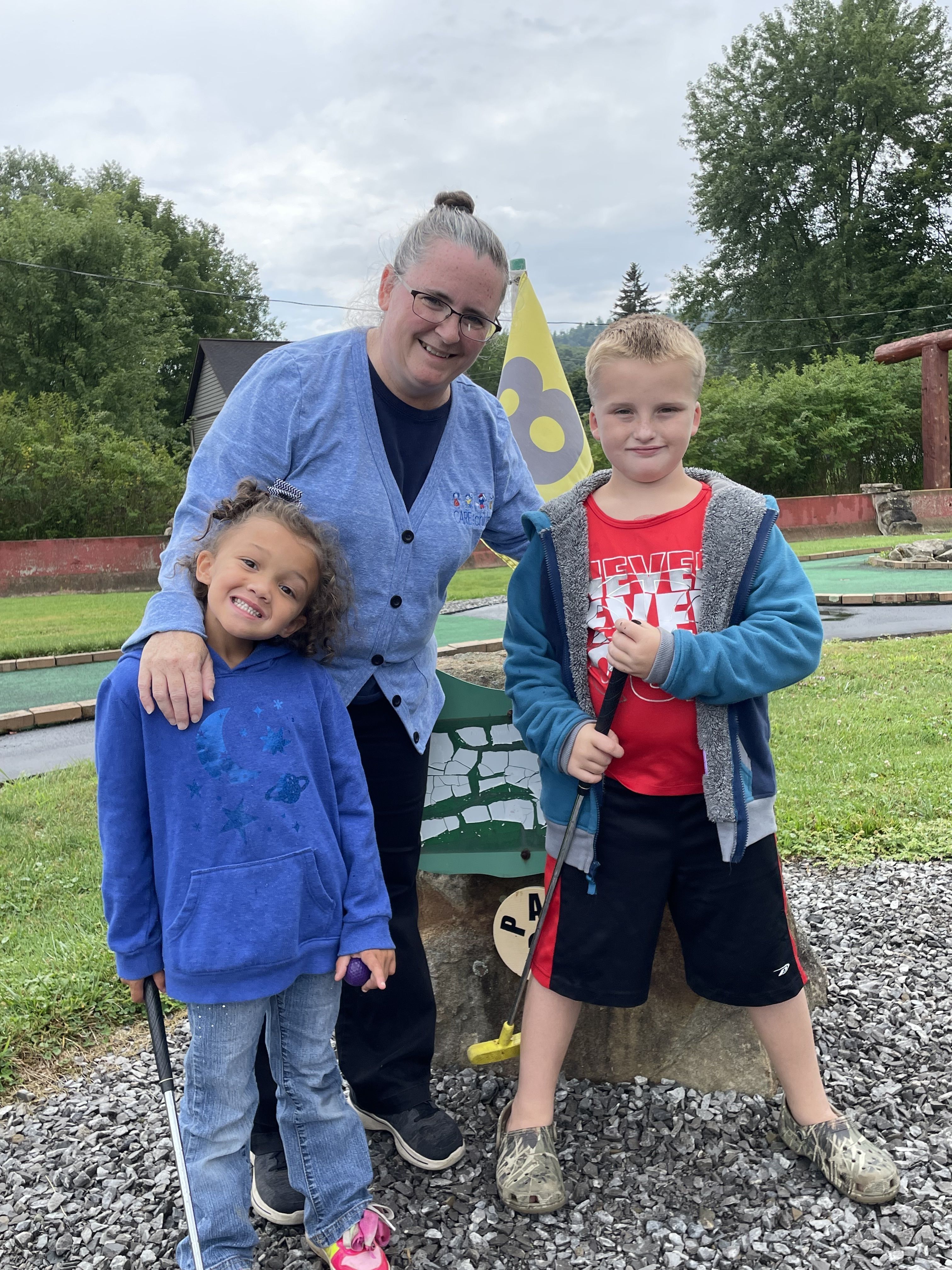 Kim Miller and two children golfing