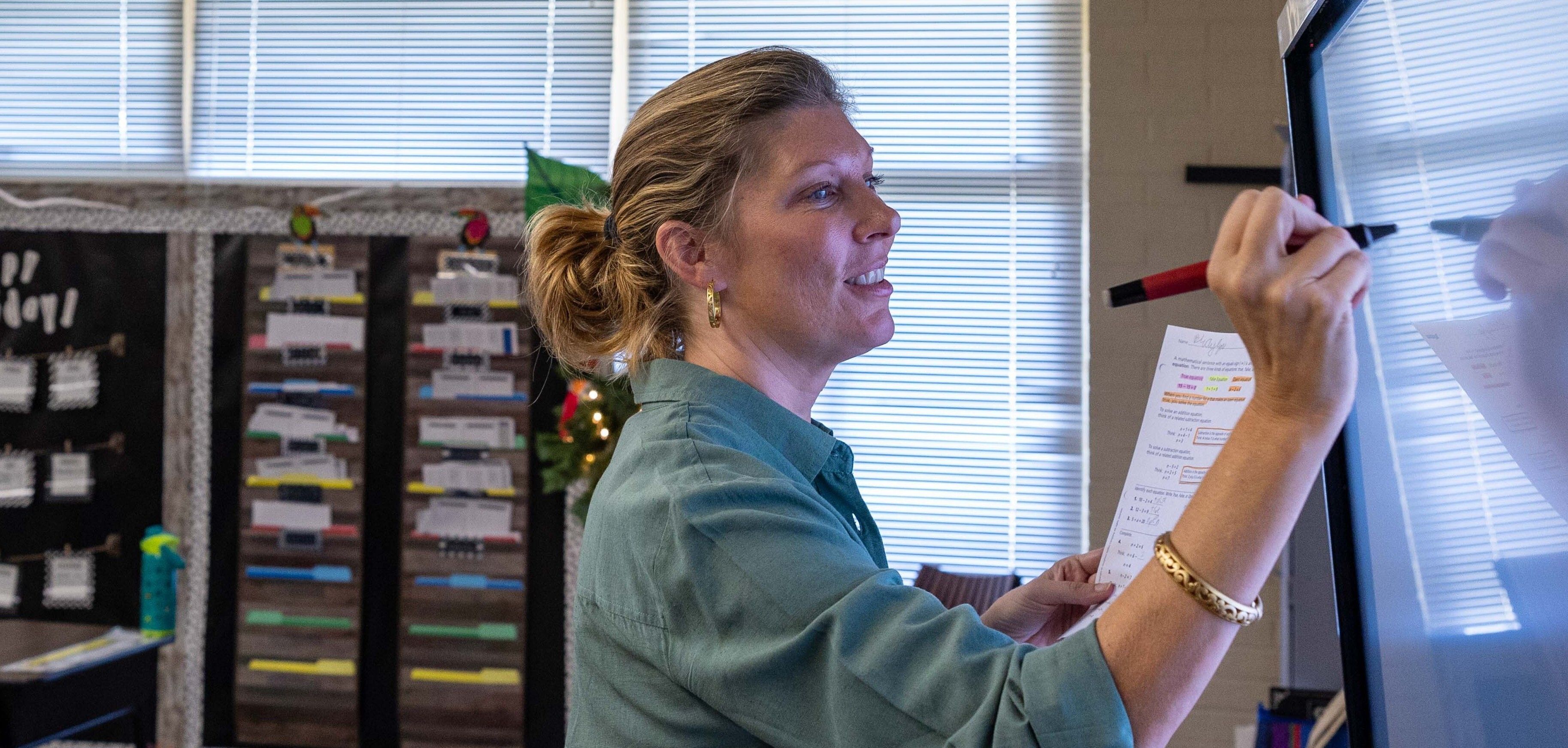 Teacher working at a white board