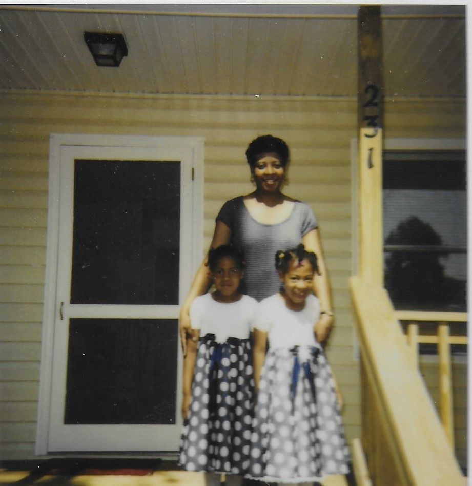 Michelle McMickens stands with her two daughters on the steps of their new Habitat home. 
