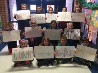 A group of children holding up papers