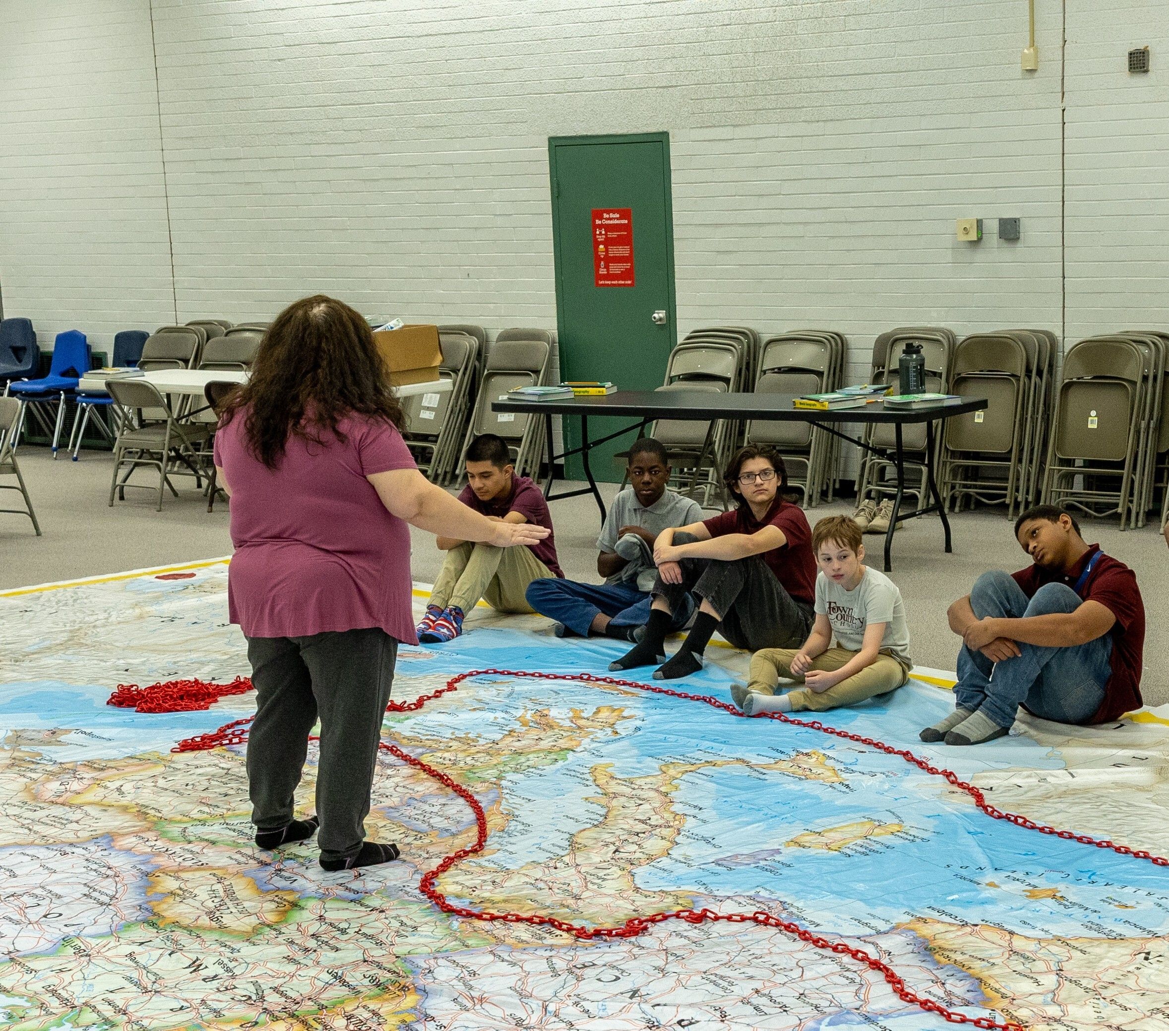 Teacher working with students on a geography lesson