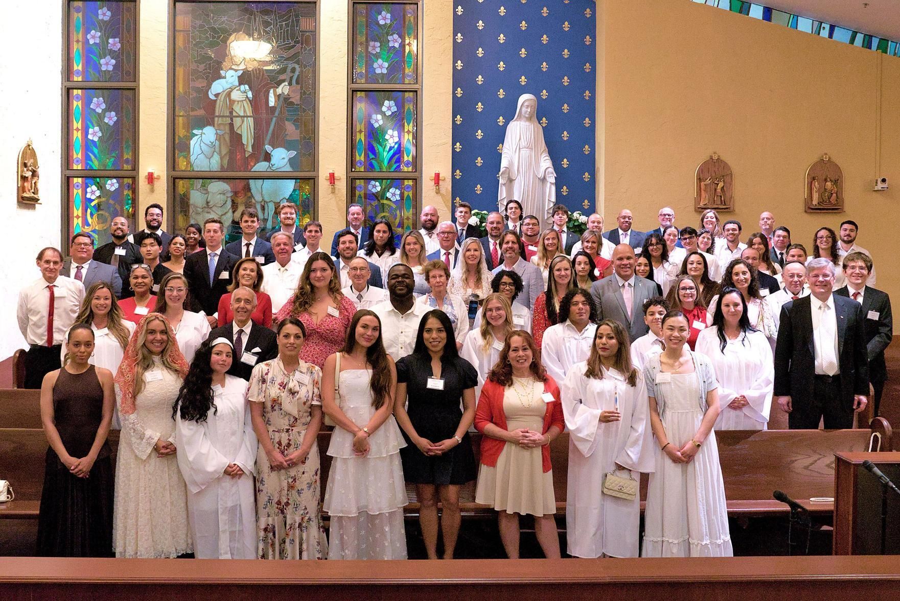 The Order of Christian Initiation of Adults group at the Cathedral of St. Ignatius Loyola, with adult faith formation director Greg Pratt, front right, following the Easter Vigil April 4, 2026.