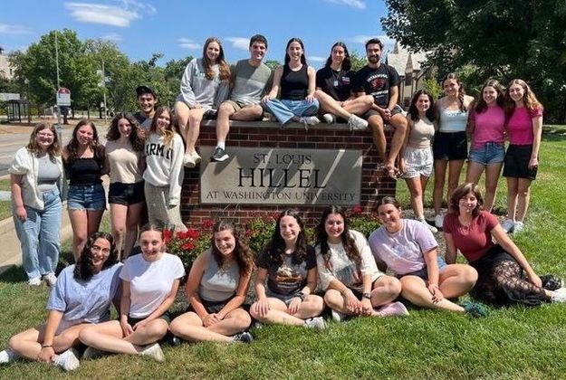 Picture of the Hillel Advisory Board in front of the Hillel sign