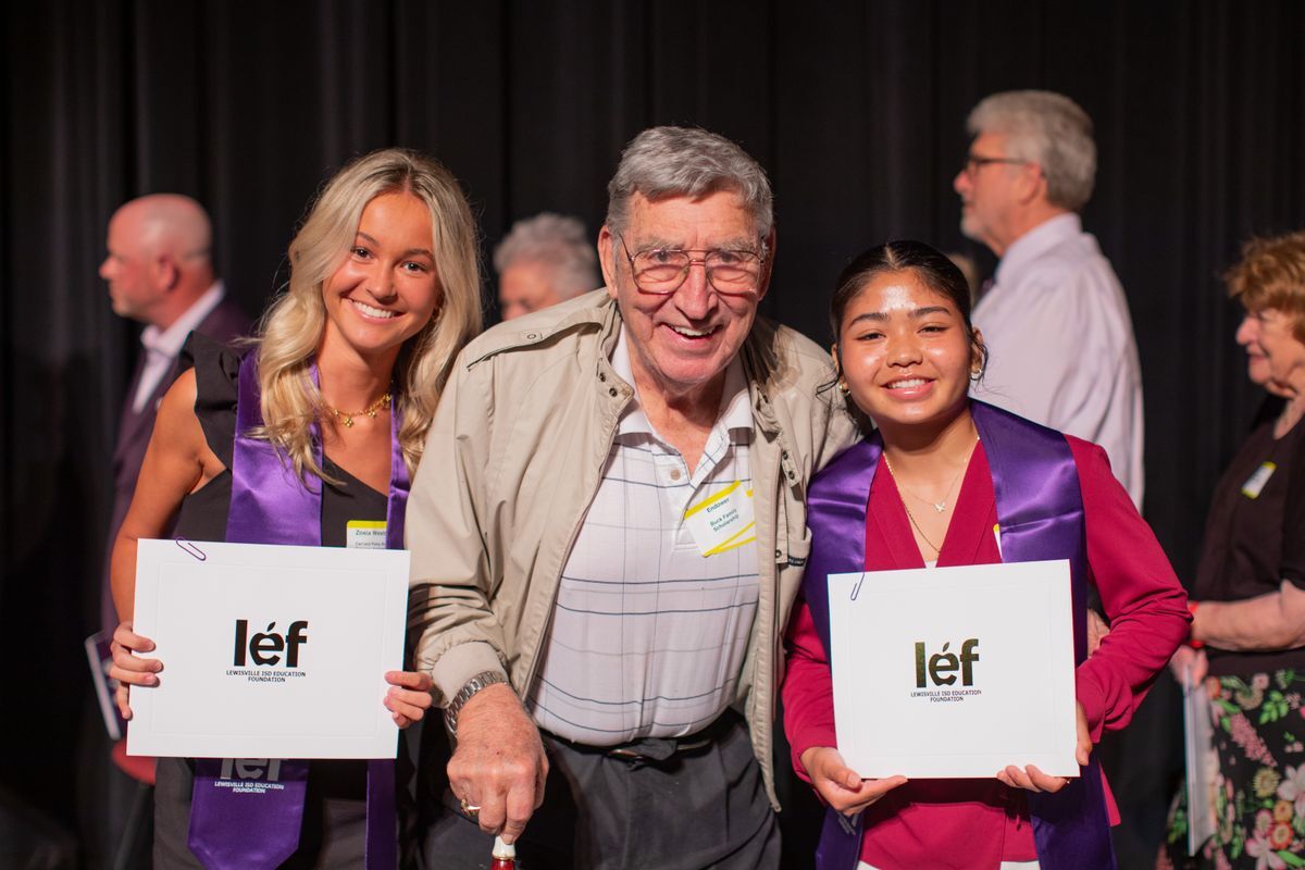 two LISD senior students smile and pose on either side of the donor who provided their student scholarships