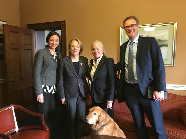 A photo of Krista Vasi, Moira Shea with guide dog Finnegan, and Mark Dunning with Congresswoman Niki Tsongas