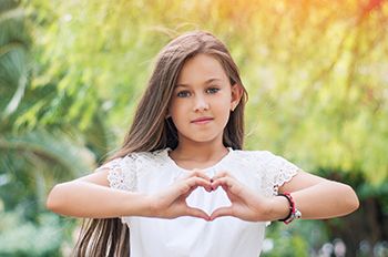 Girl making a heart symbol with hands