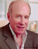 J.M. McDonough. A man who is in his 70's wearing a suit and posing for the picture, there is text in the bottom right corner that reads "JM (Marty) McDonough"