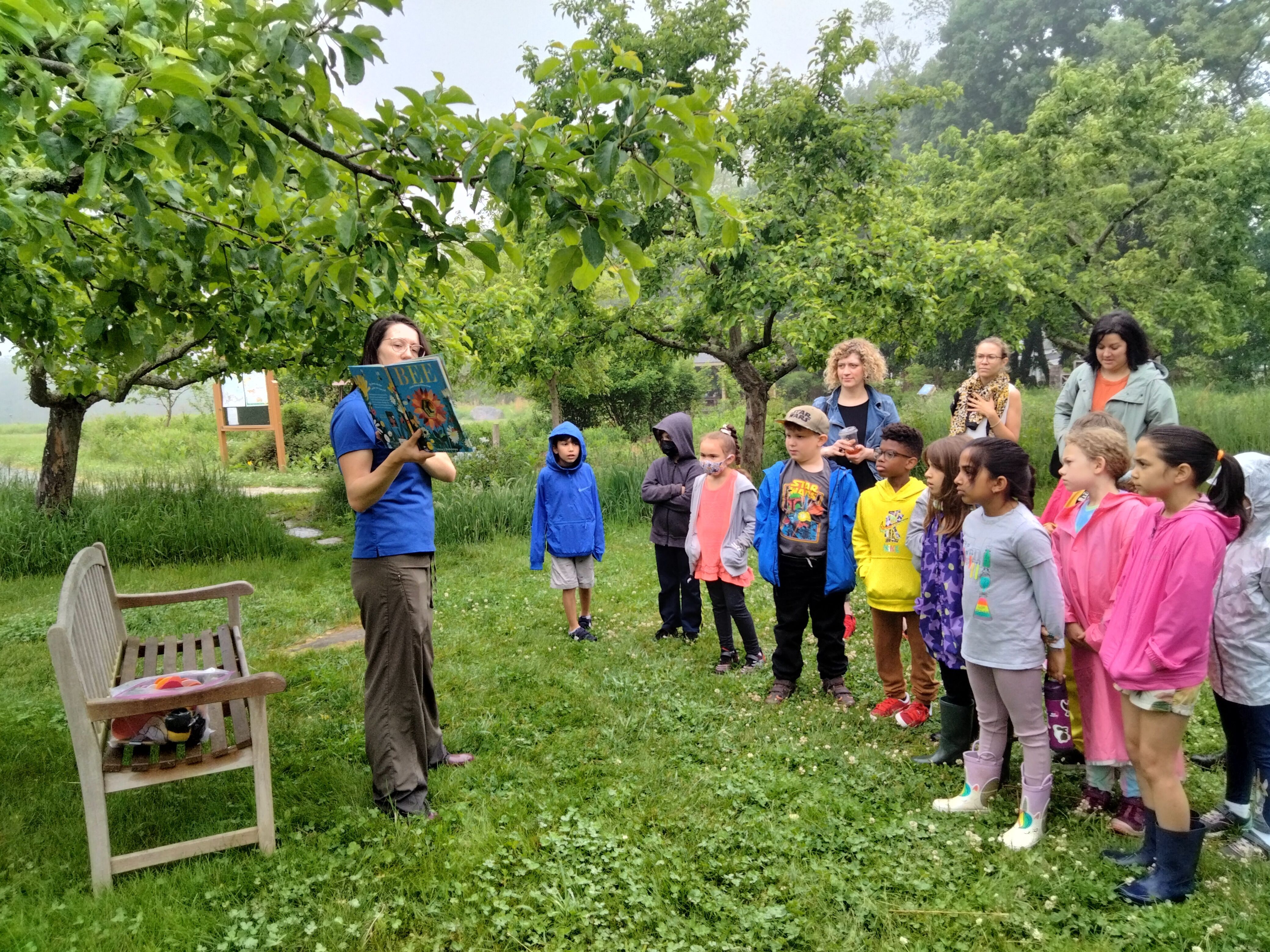 Croft School Students listen to a nature story in pollinator garden