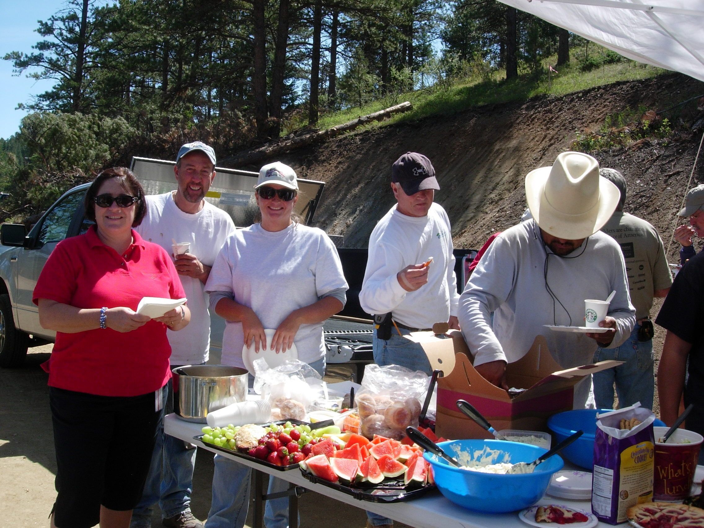 Construction volunteer group having a break on site