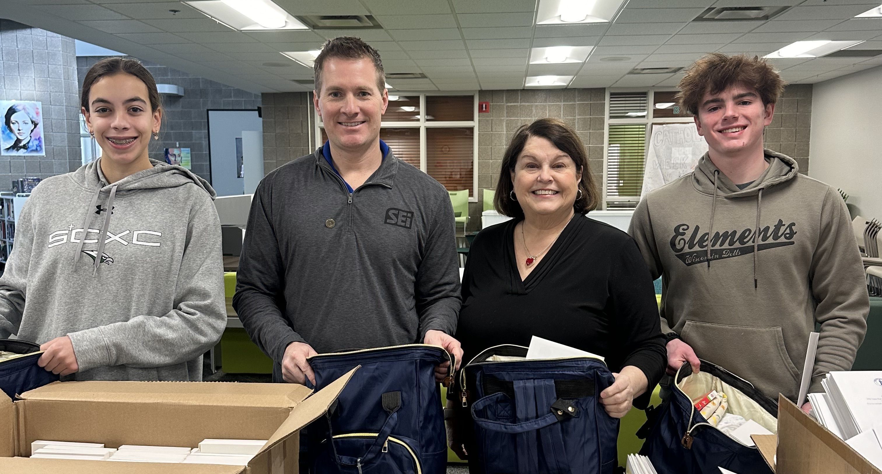 Christ Child Society of Omaha board members and volunteers pack bags, also known as layettes, filled with newborn essentials