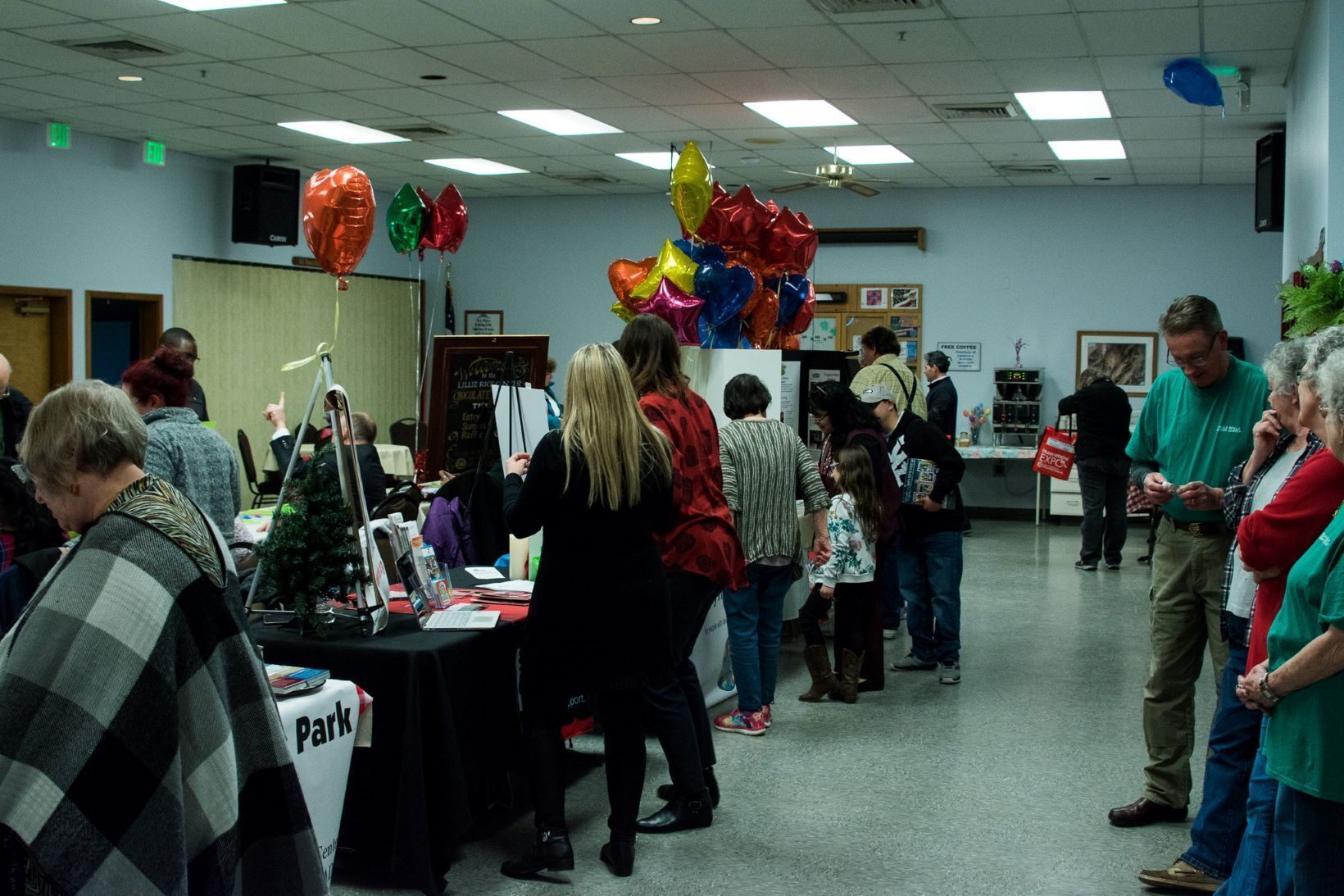 Group of people at Transition Expo talking to people seated behind tables