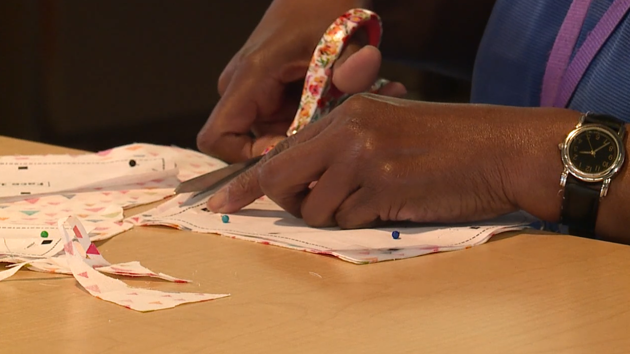 Person cutting out mask pieces from fabric