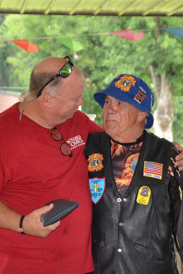 BGHNC Chief Mission Officer Ray Cockrell accepts the funds raised during the Wilmington Optimist Benefit Ride from CMA's Paul Elswick.