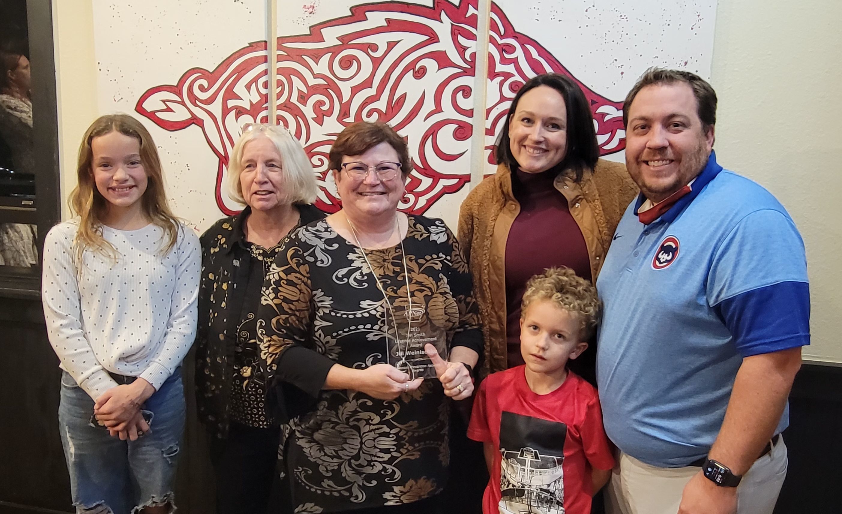 Jill Weinischke (center) and the Jim Smith family