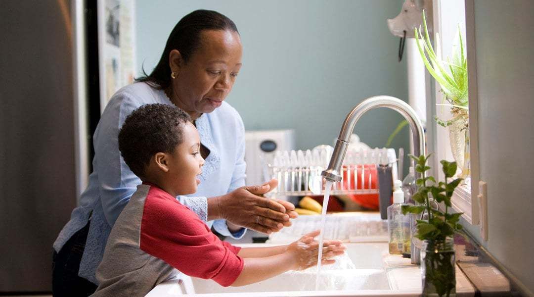 Woman and Boy at Kitchen Sink