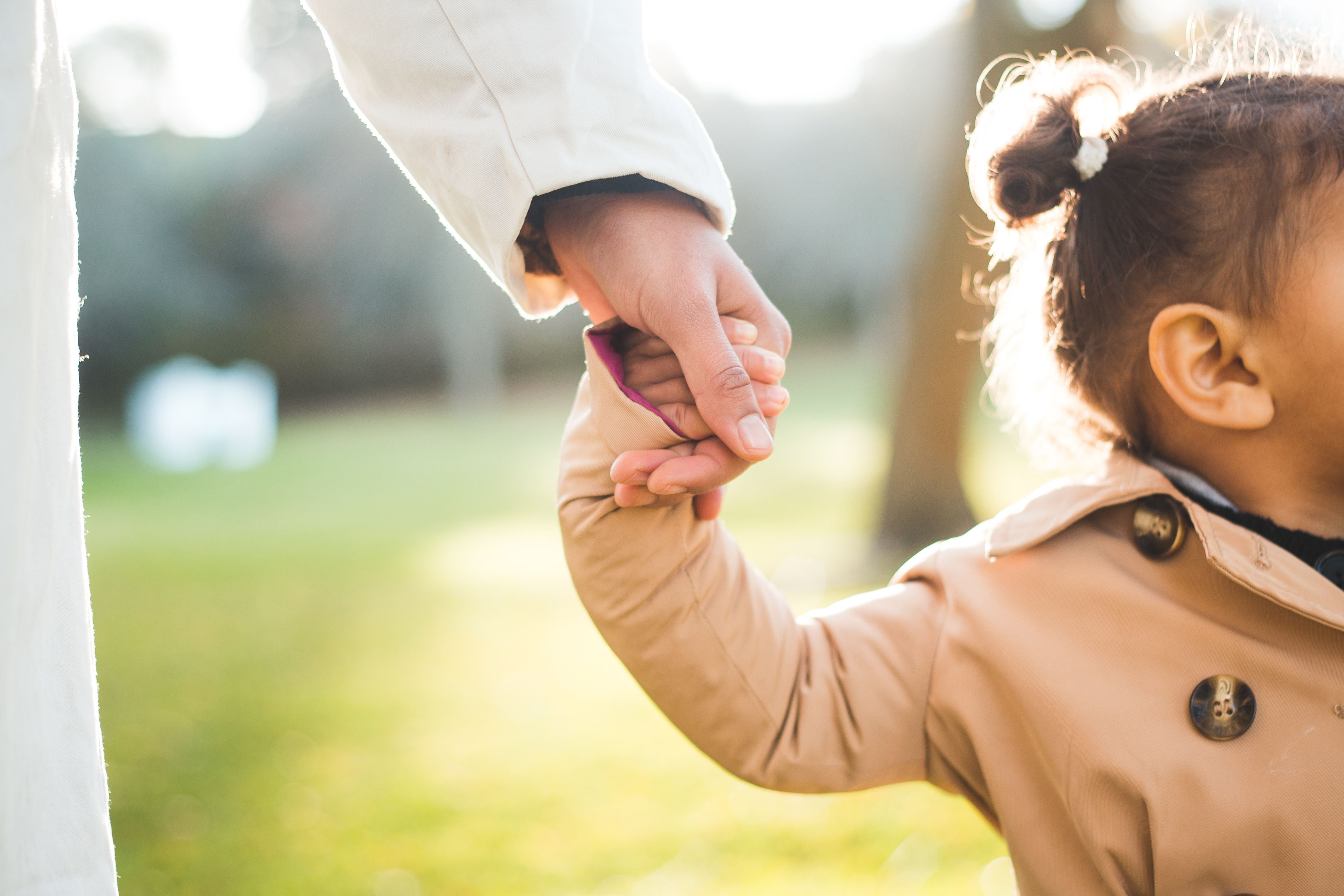 Parent holding child's hand
