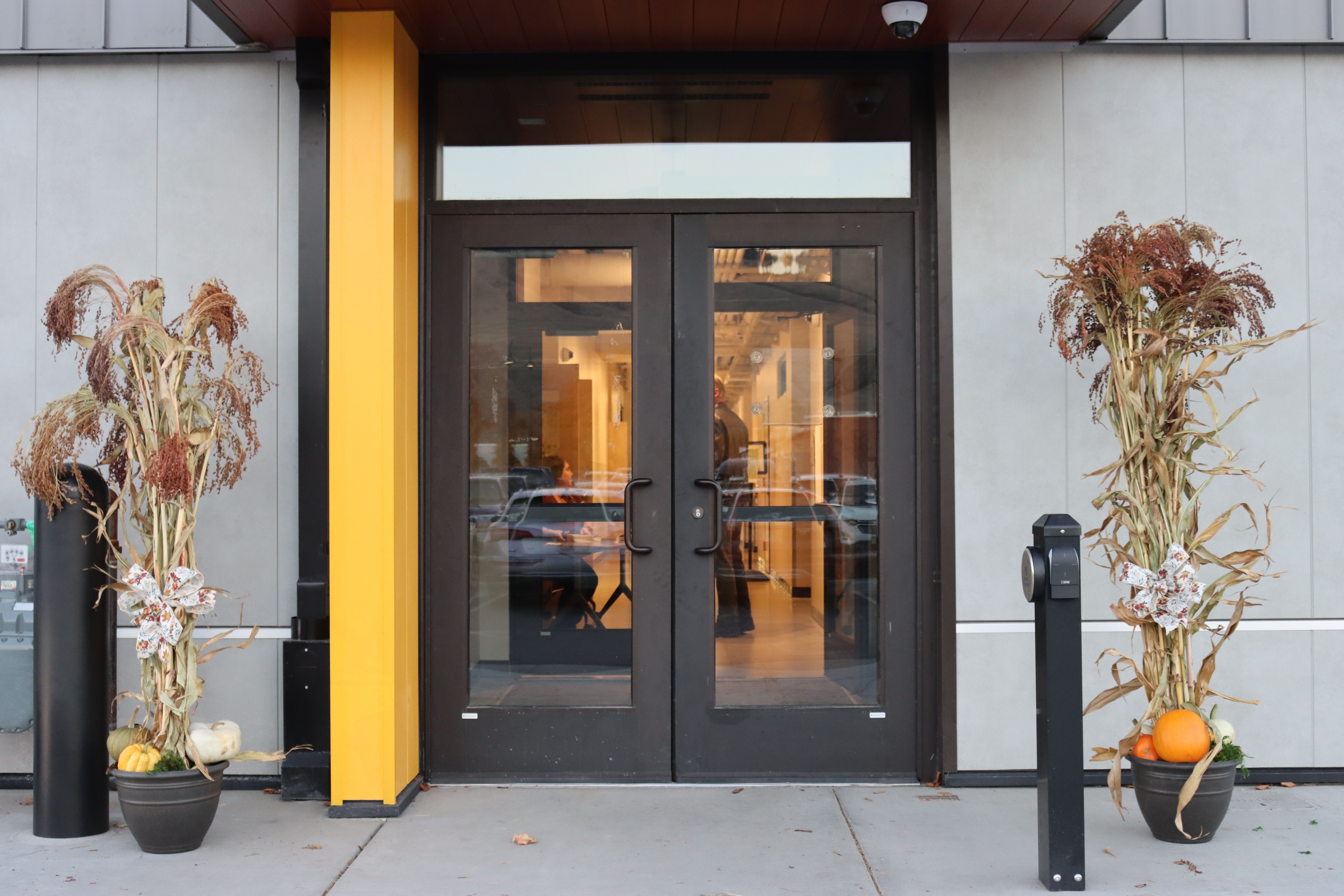 Exterior doorway with fall decorations.