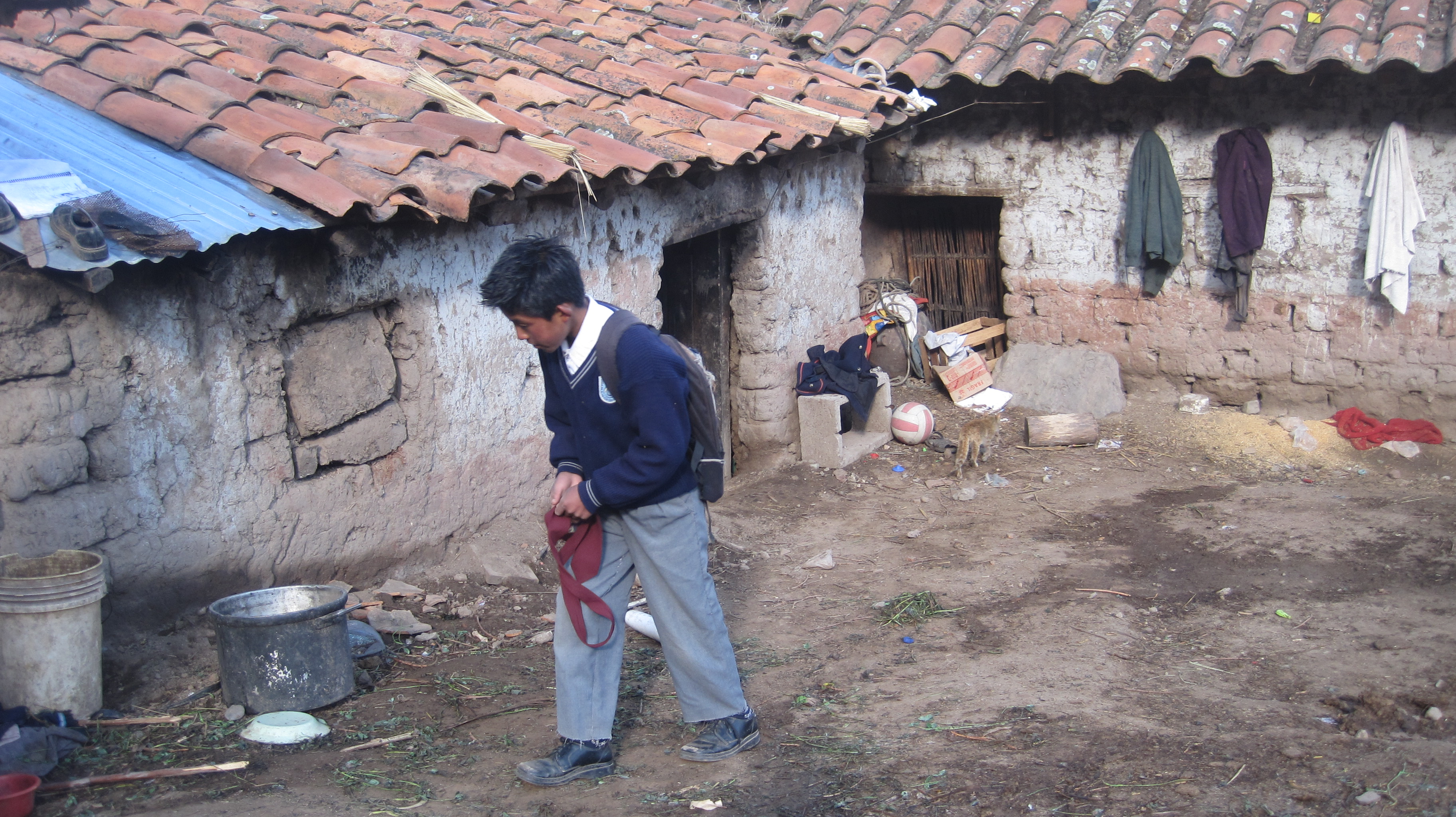 Student of "San José Obrero" School in front of his home (Pomacanchi, Peru)