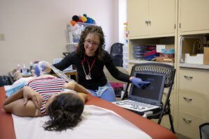 Woman doing an ultrasound on another woman.