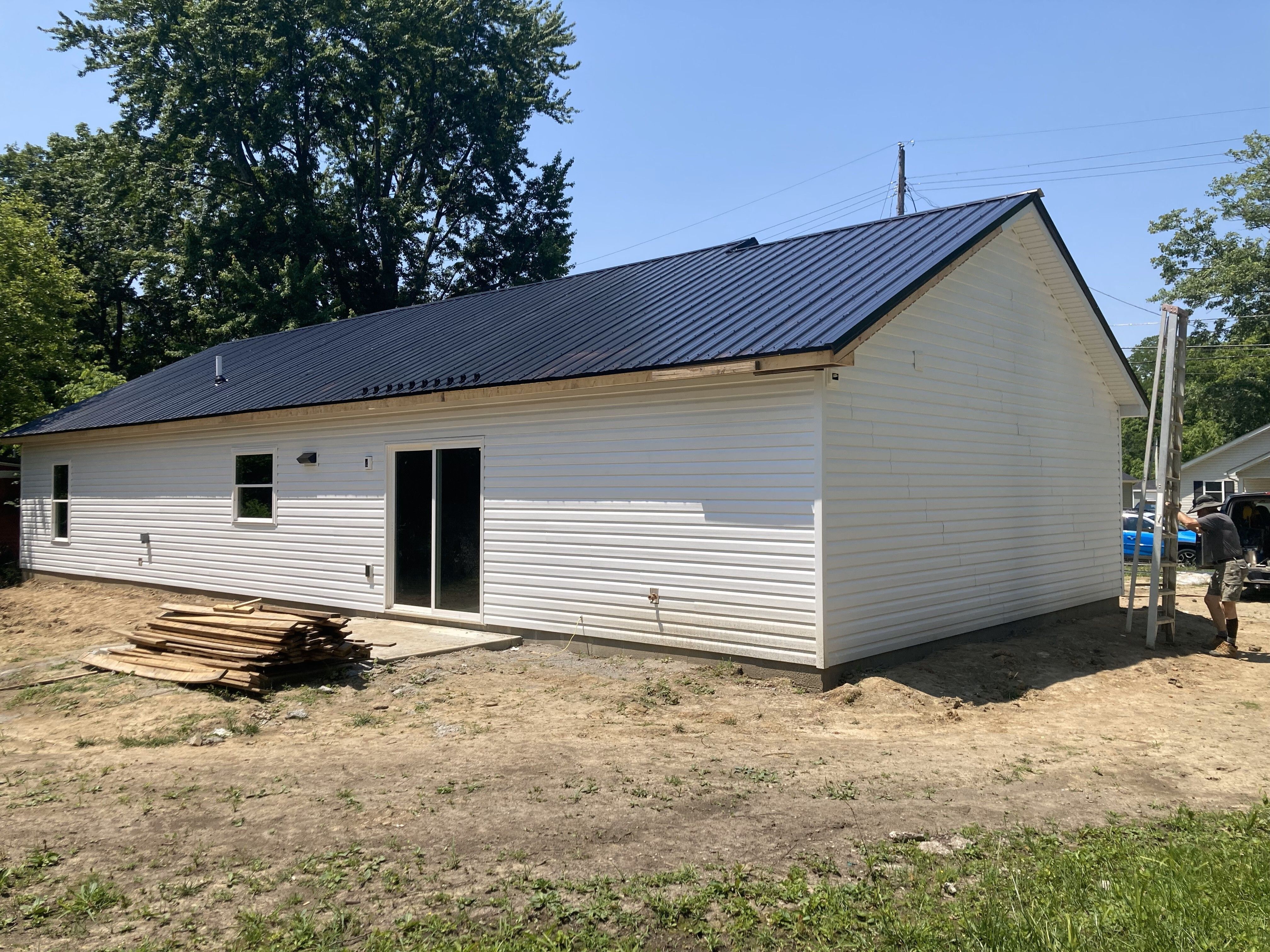 Siding, doors and windows installed. Metal roof is in process on Mulberry St