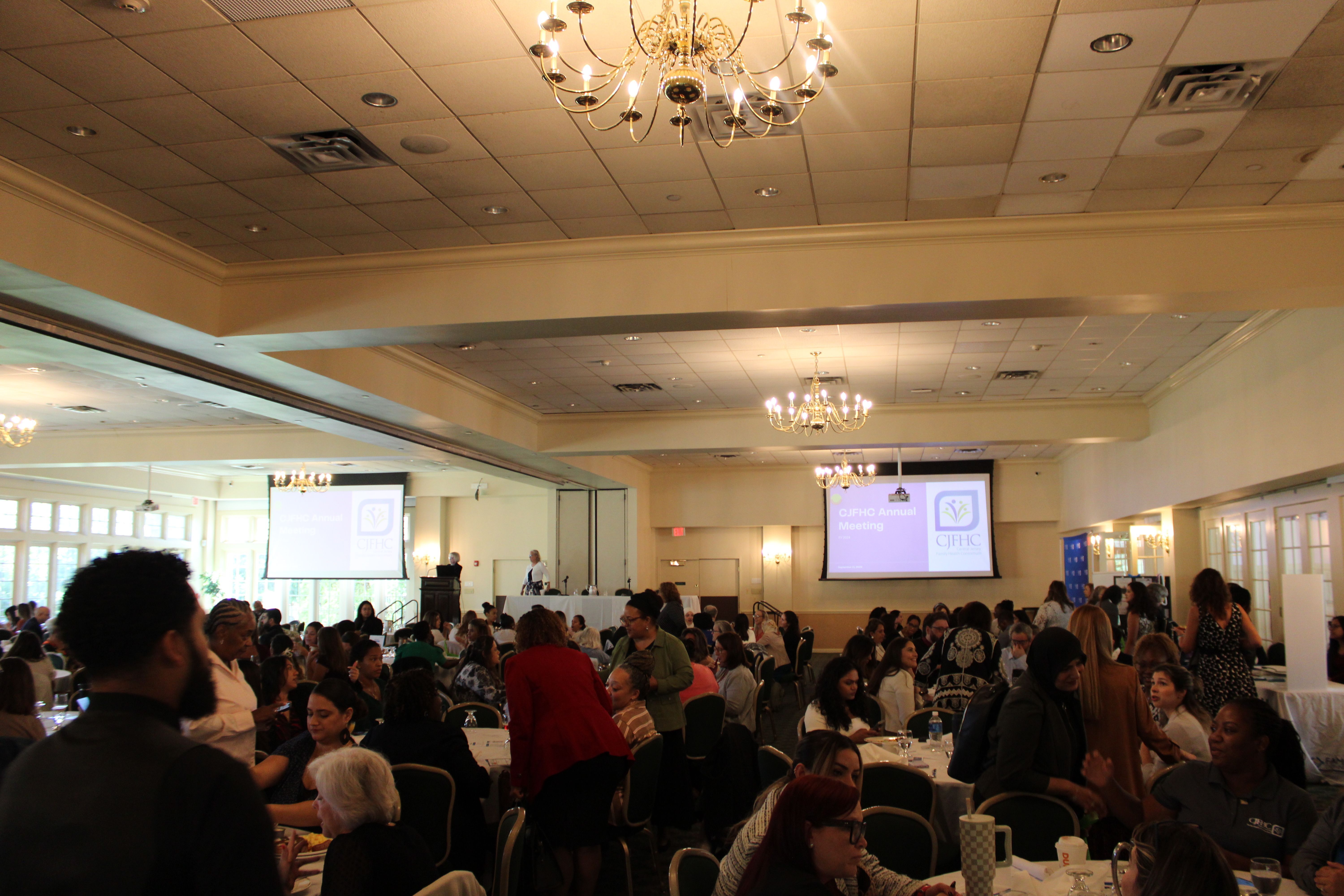 All members are seated in a large ballroom at the annual meeting