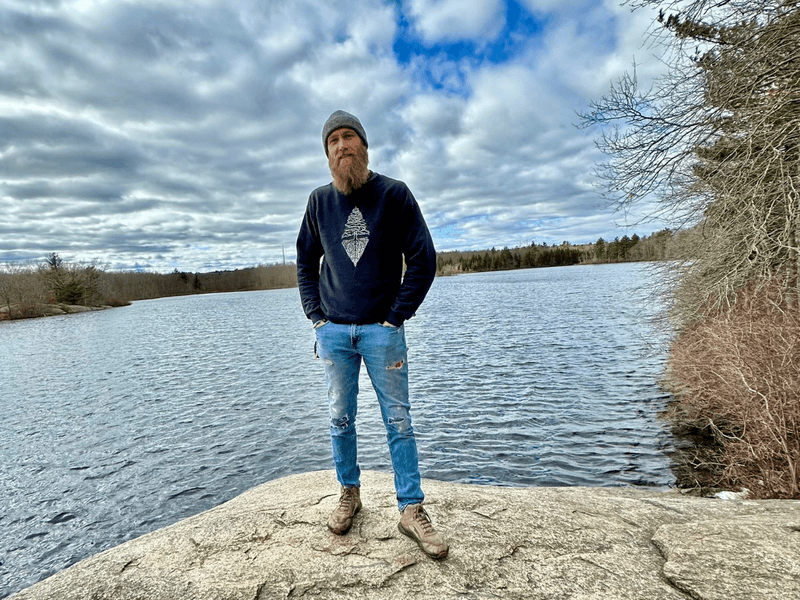 Photo of Samuel Mohnkern standing in front of a lake