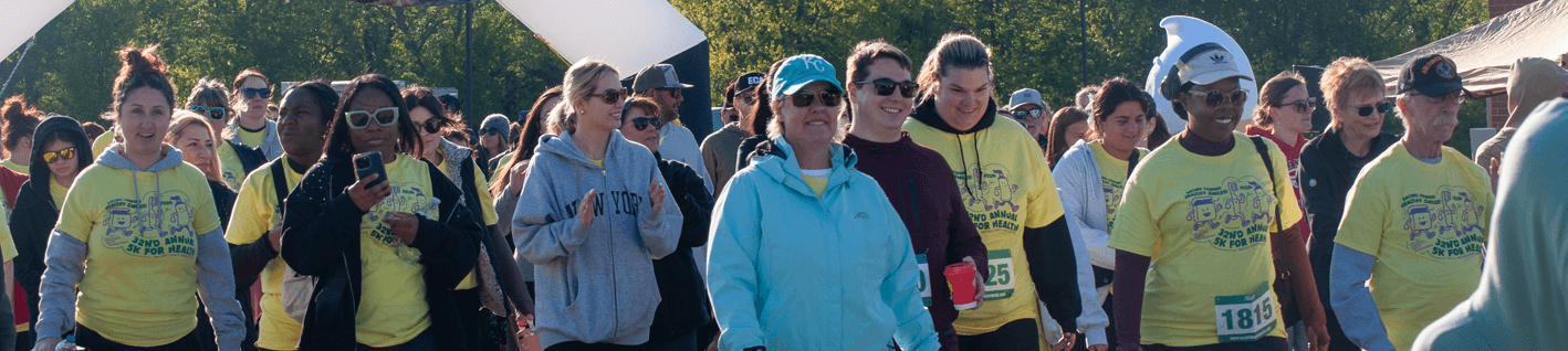 group of runners and walkers at a race starting line