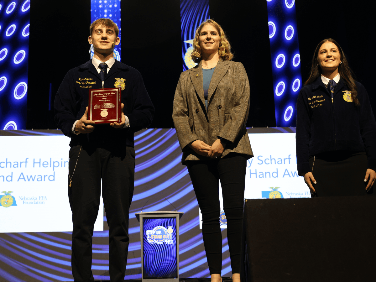 Osmond FFA Advisor Jessica Evans accepts the 2026 Gary Scharf Helping Hand Award at the 98th Nebraska State FFA Convention.