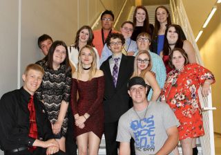 Group of students with and without disabilities wearing homecoming attire