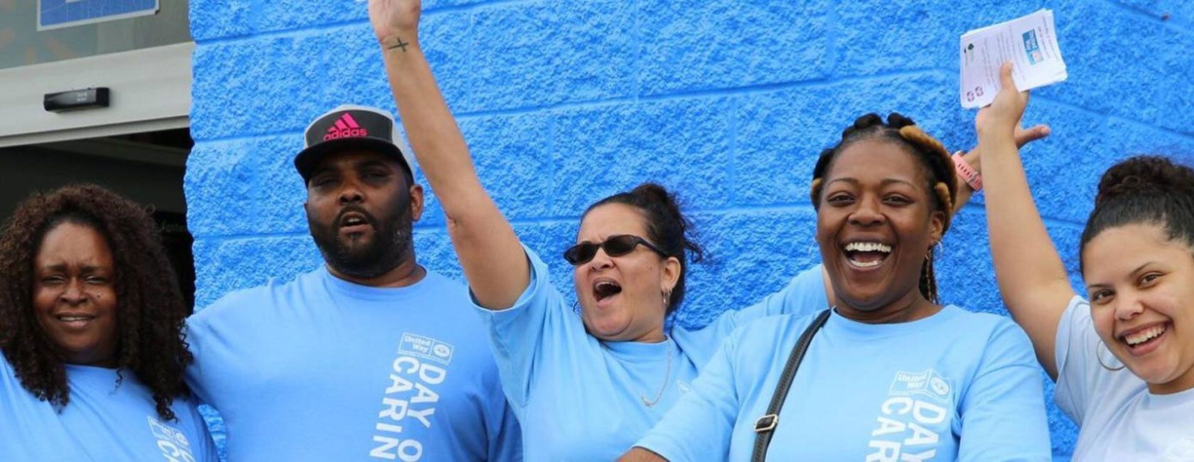 Group of people raising hands outside