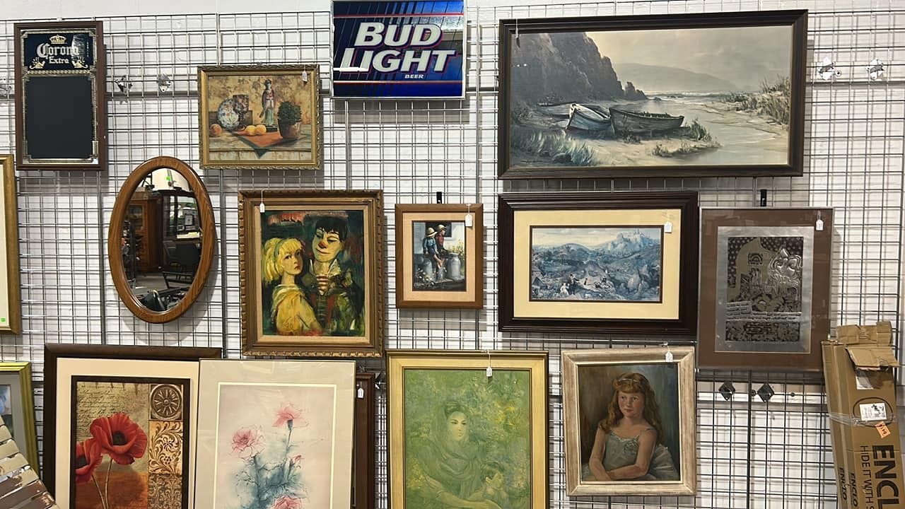 Assorted framed artwork, vintage prints, and mirrors for sale at Habitat ReStore Zephyrhills — affordable wall décor and unique home accents