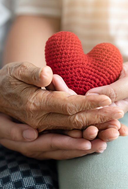Hands holding a knitted heart
