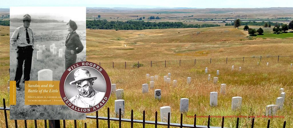 Fenced in gravesite with multiple white headstones.